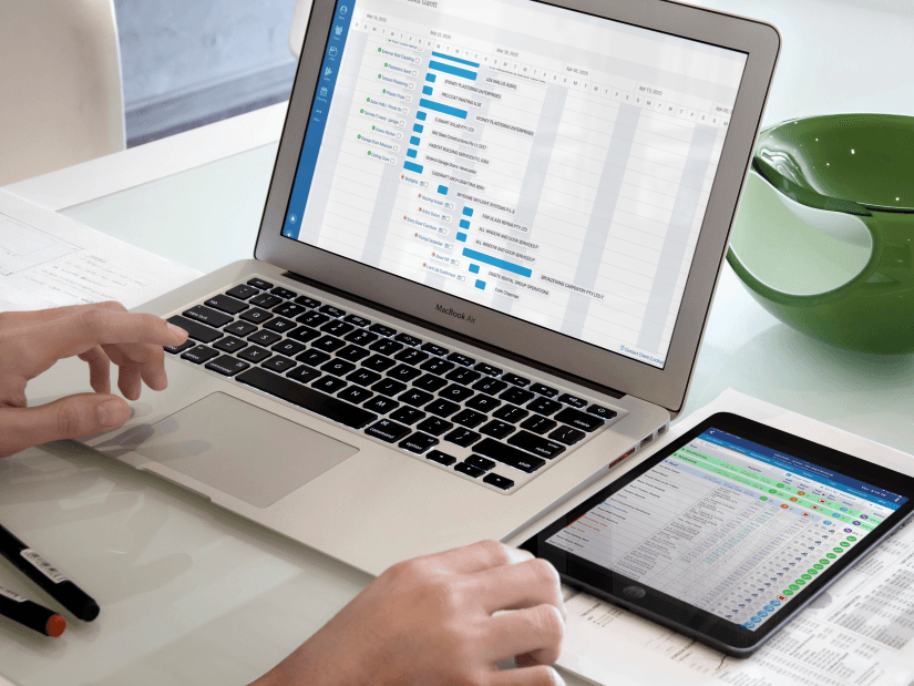 ClickHome open on a laptop and tablet, showing live job visibility