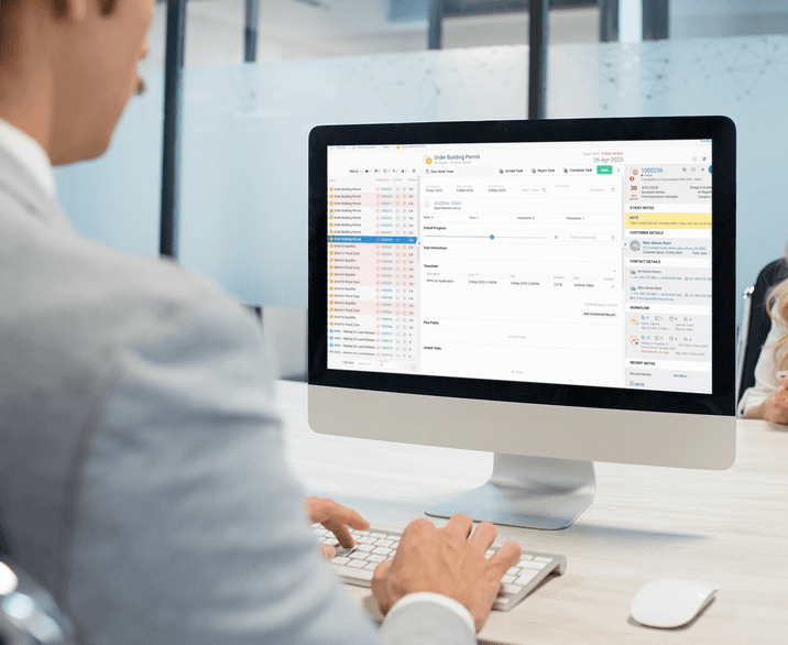 A builder reviewing ClickHome on a desktop in the office